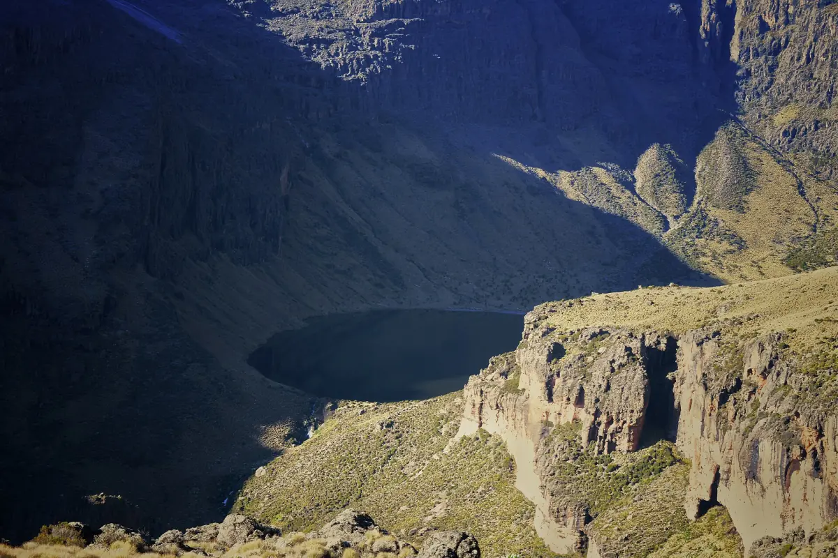 Lake Michaelson lies in shadow beneath sunlit crags and ridges