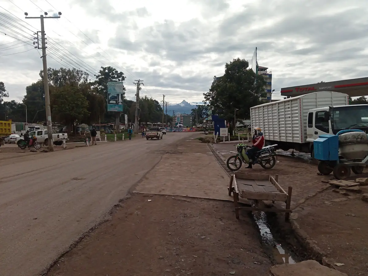 Street scene in Nanyuki town with trees and a delivery truck