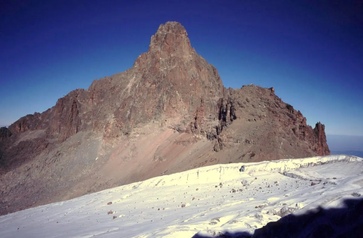 Reddish Nelion peak above the Lewis Glacier ice field